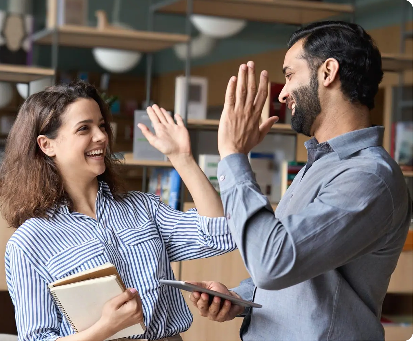 A man standing next to a woman holding a binder.